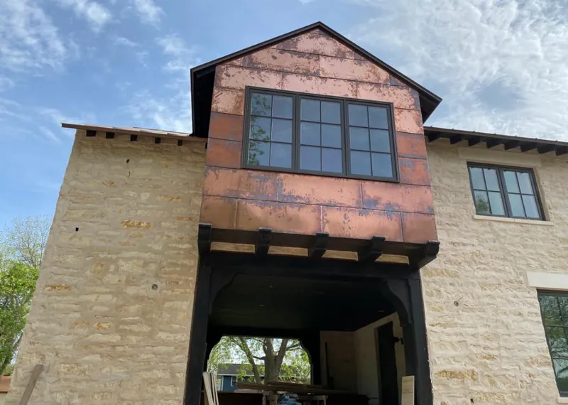 Copper metal panel facade on a stone building for Skylight Installation in Newfane
